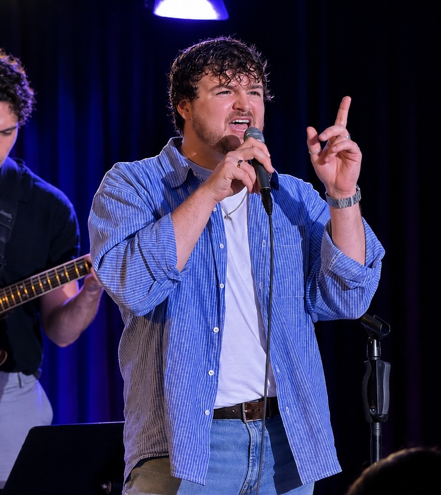 Brynden Foster performing with a microphone